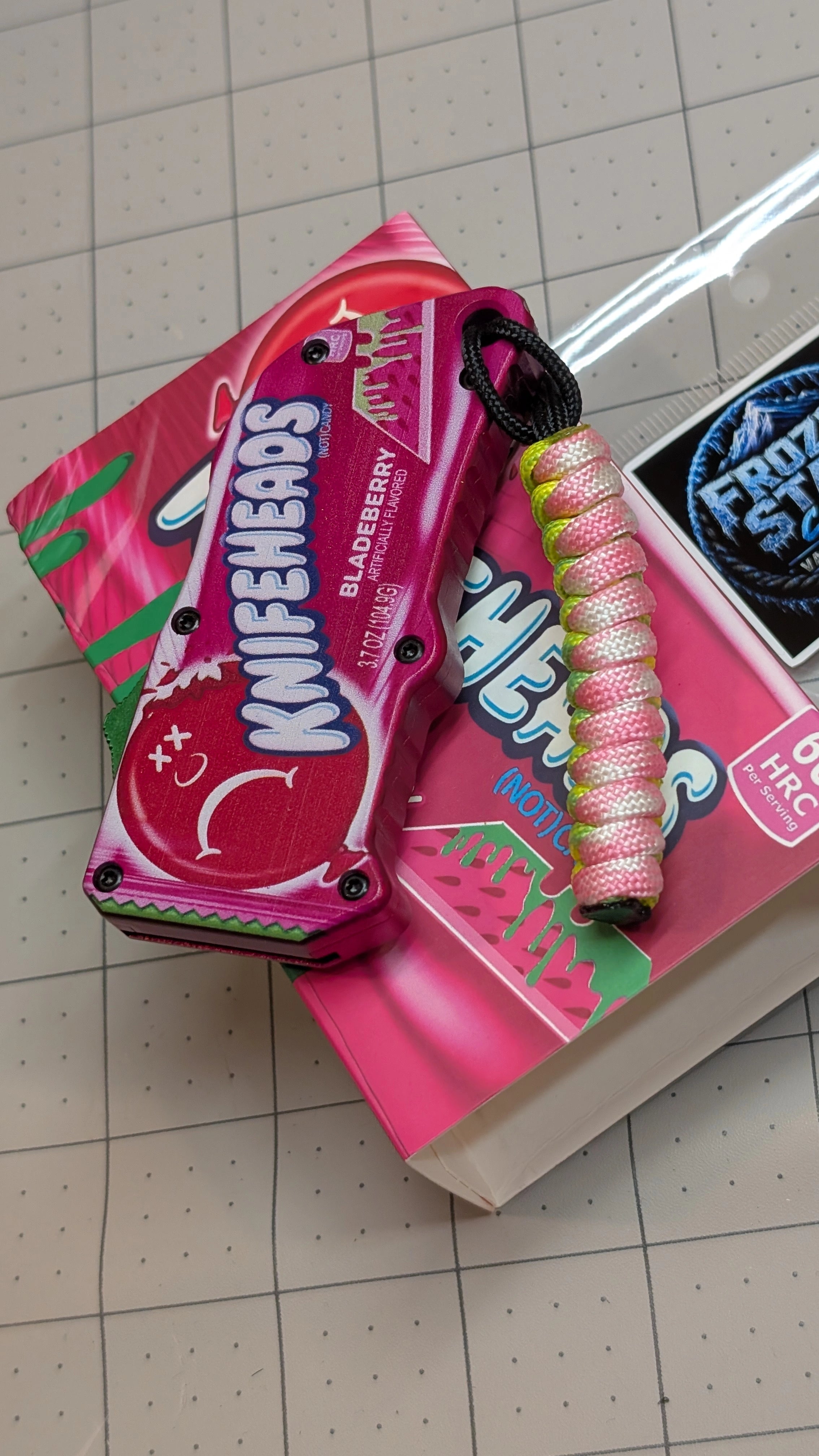 Frozen State Cords paracord lanyard, neon pink and yellow, Sour Patch Knife Utility Blade edition, on box